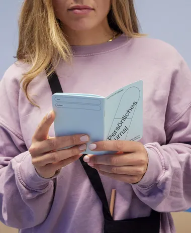 Close up of a girl reading the personal guide.