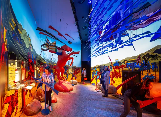 Image of the Conventional war room, where a staggering horse and hanging guns square off in a room with bright graphics.
