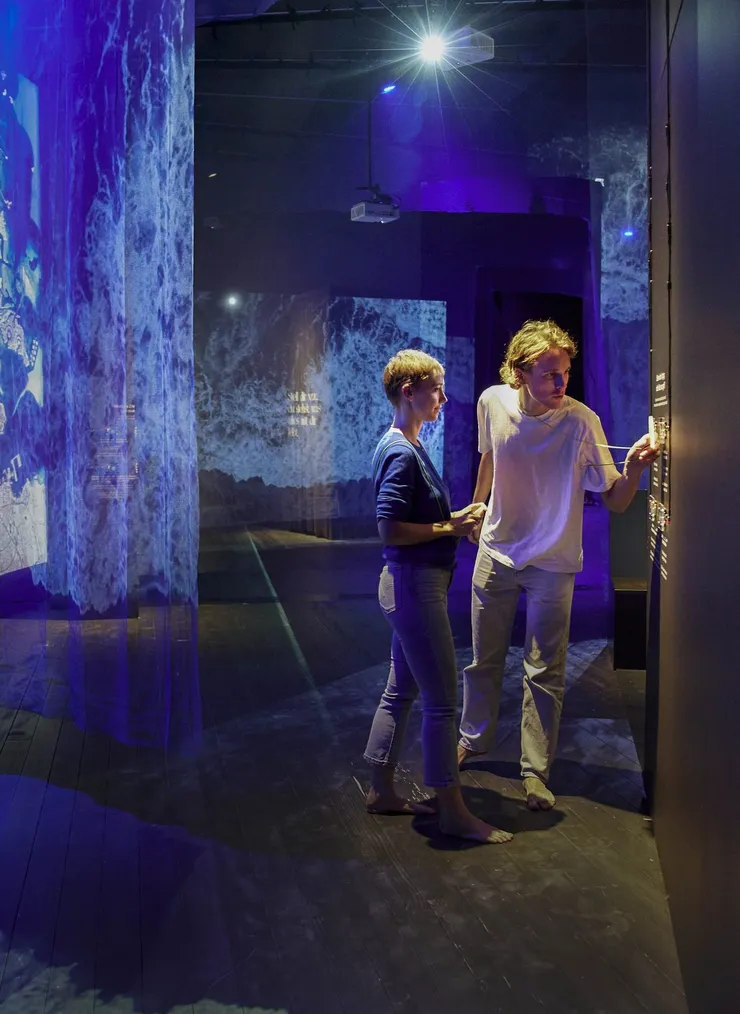 Two visitors scan their compasses.