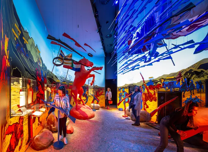 Image of the Conventional war room, where a staggering horse and hanging guns square off in a room with bright graphics.