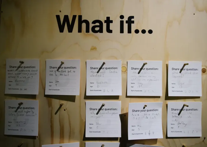 What if on a wooden board, with written white notes pinned underneath.
